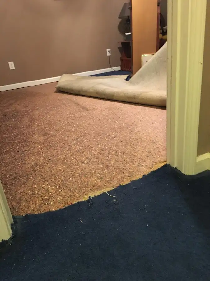 Carpet pad removal revealing water damage during Water Mitigation Services in Cedar City